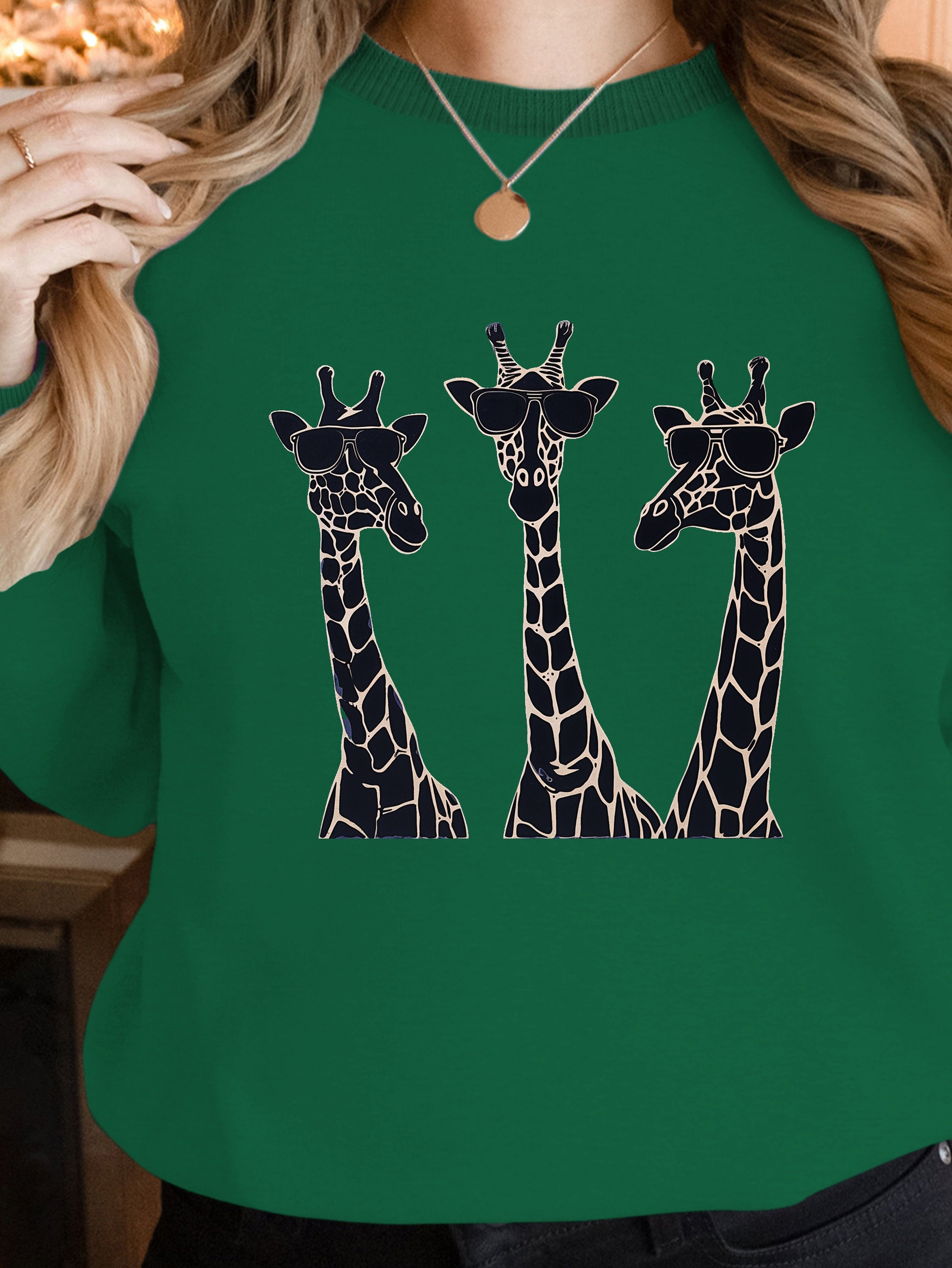 Playful giraffes wearing sunglasses women's sweatshirts