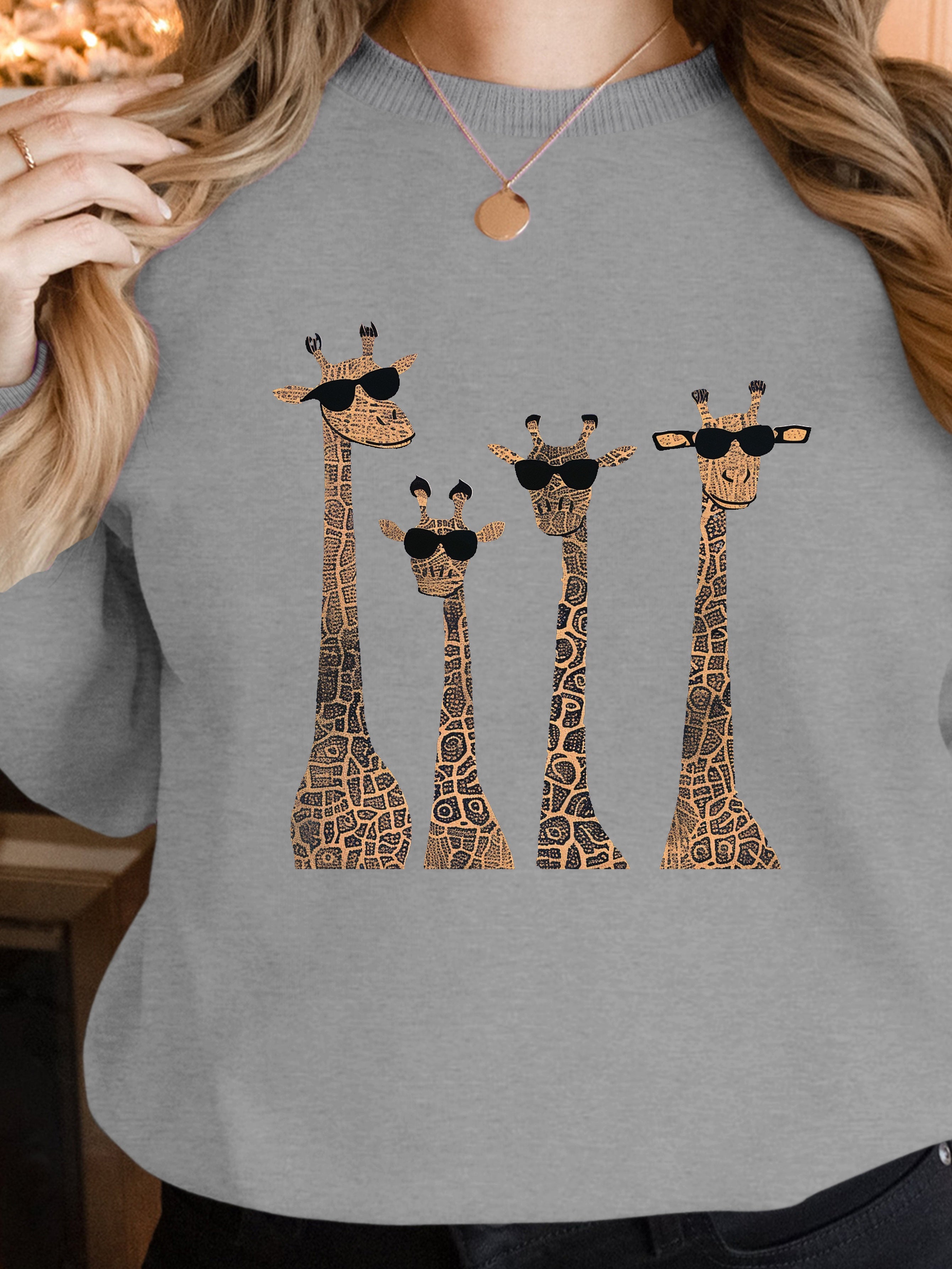 Playful giraffes wearing sunglasses women's sweatshirts