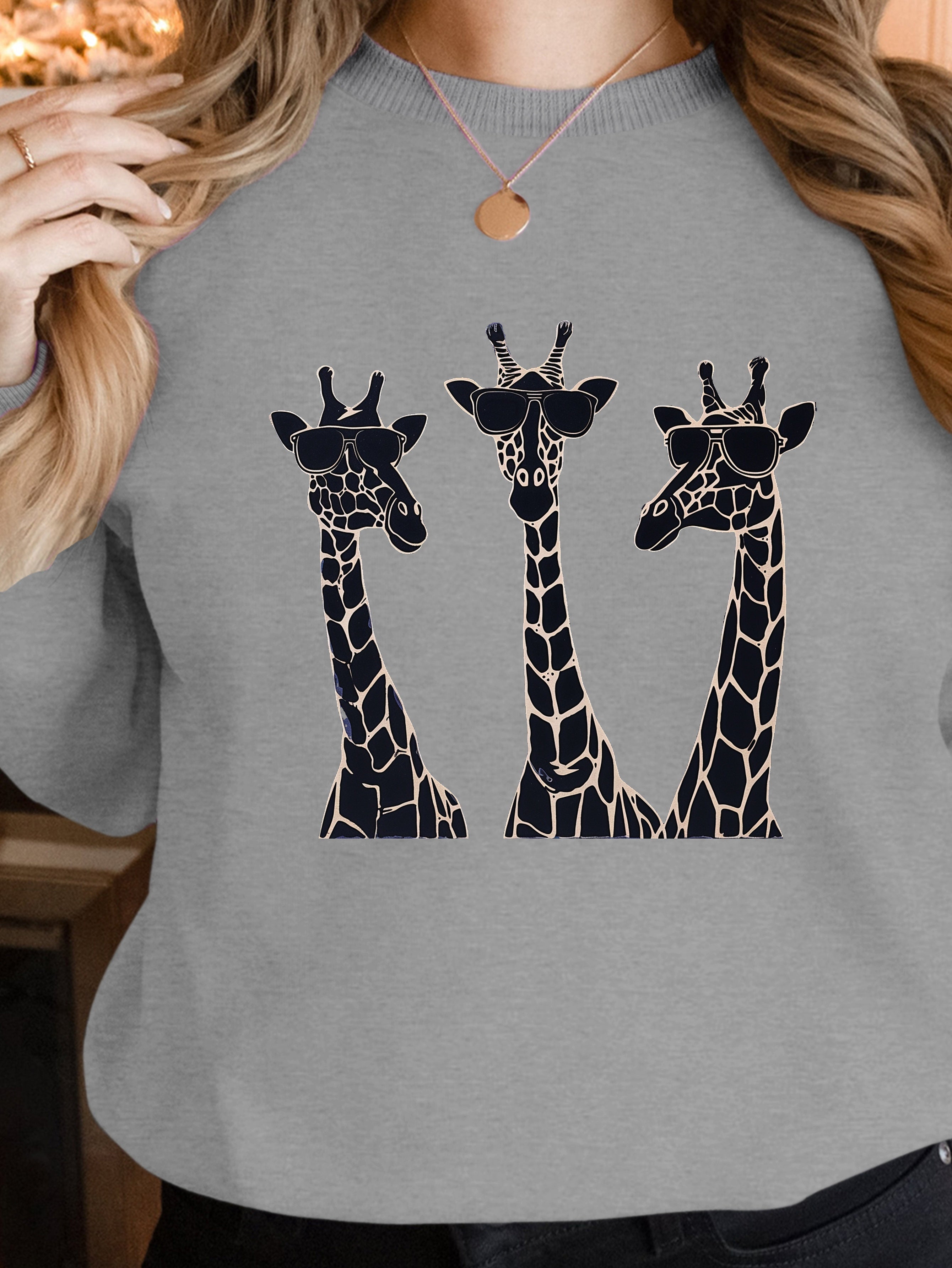 Playful giraffes wearing sunglasses women's sweatshirts