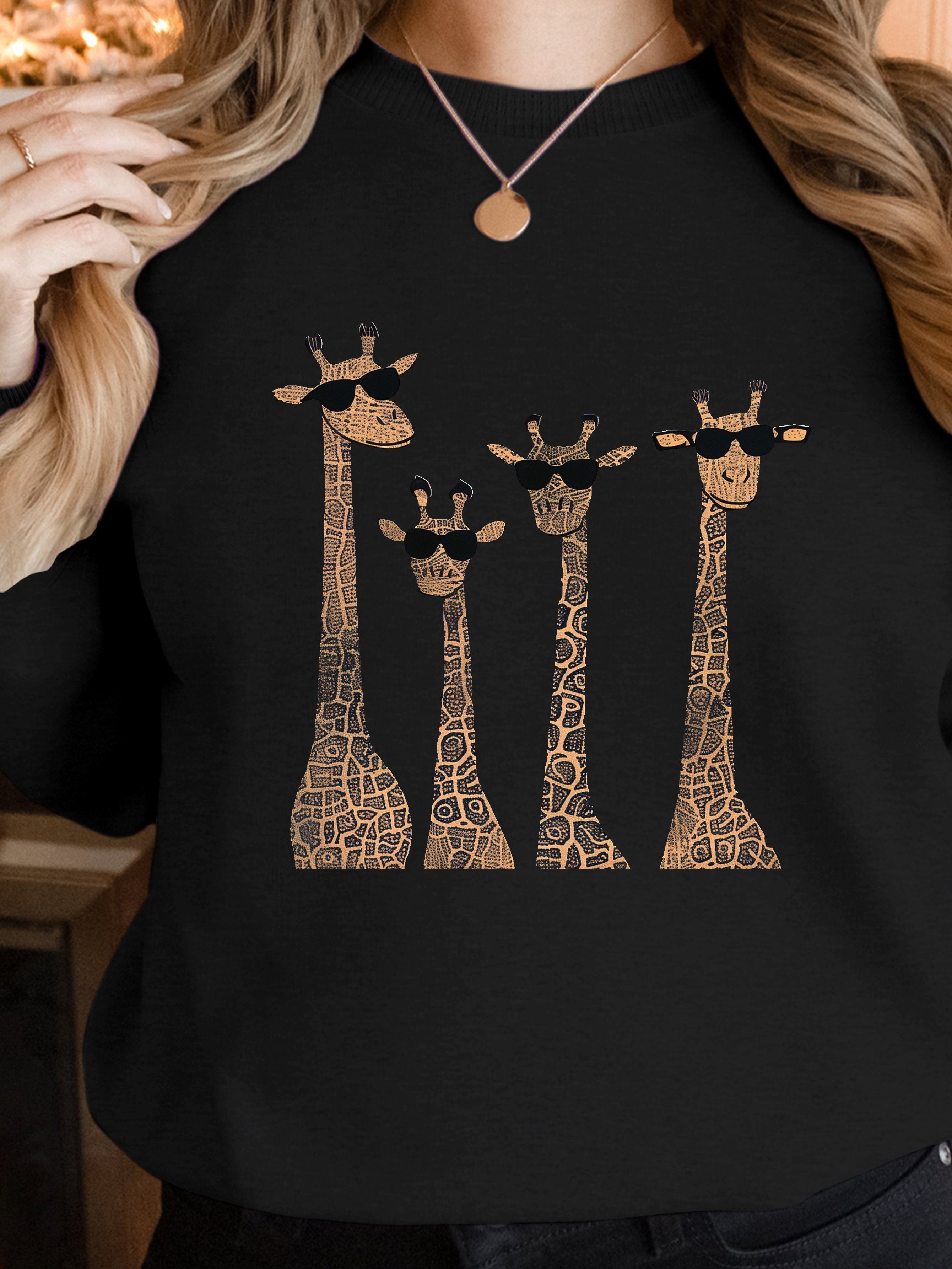 Playful giraffes wearing sunglasses women's sweatshirts