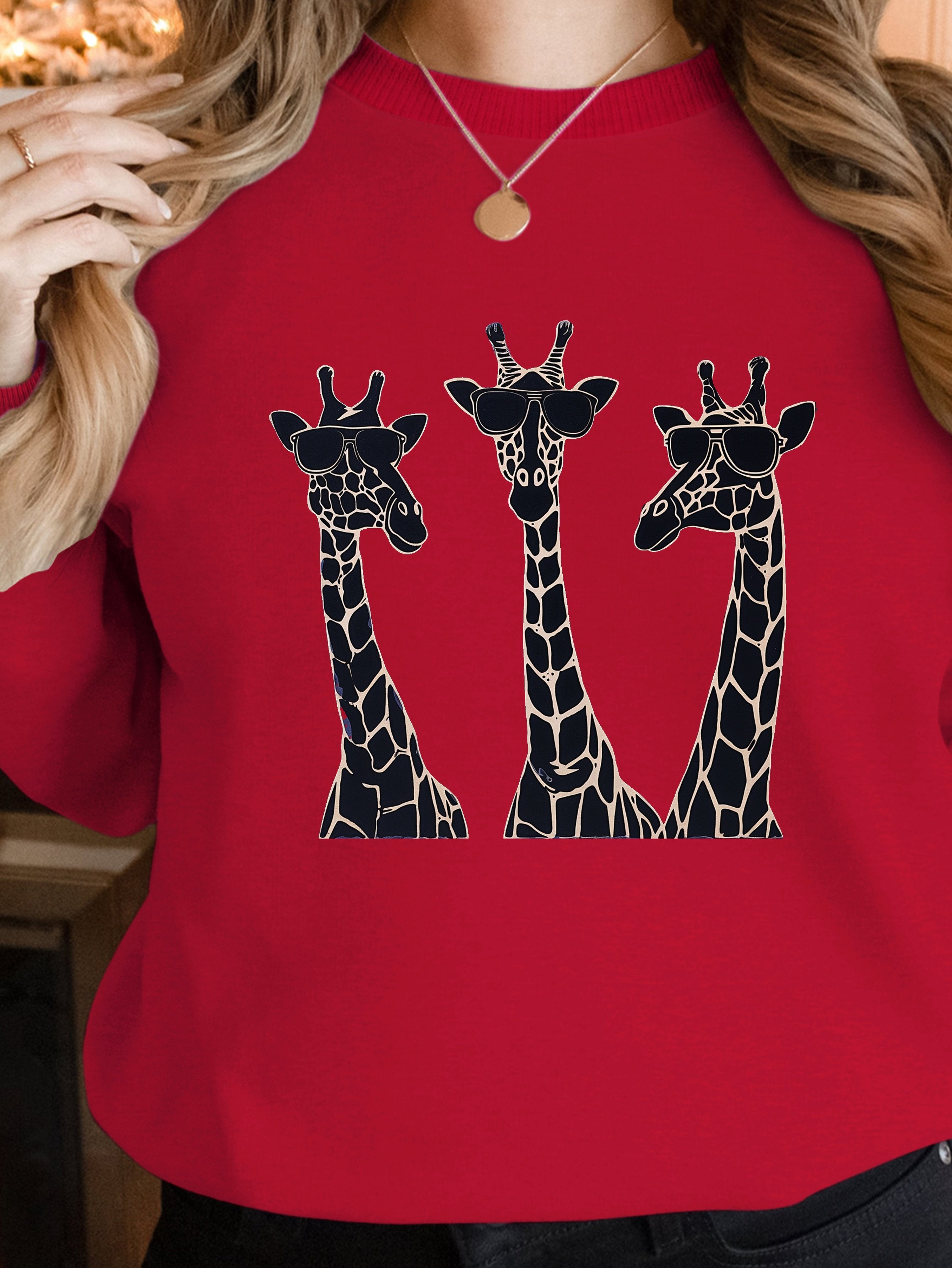 Playful giraffes wearing sunglasses women's sweatshirts